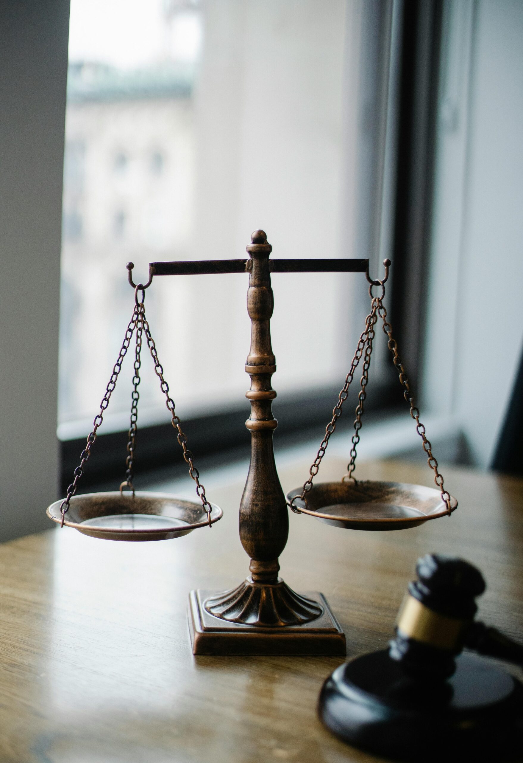 Scales Of Justice And Gavel On Desk