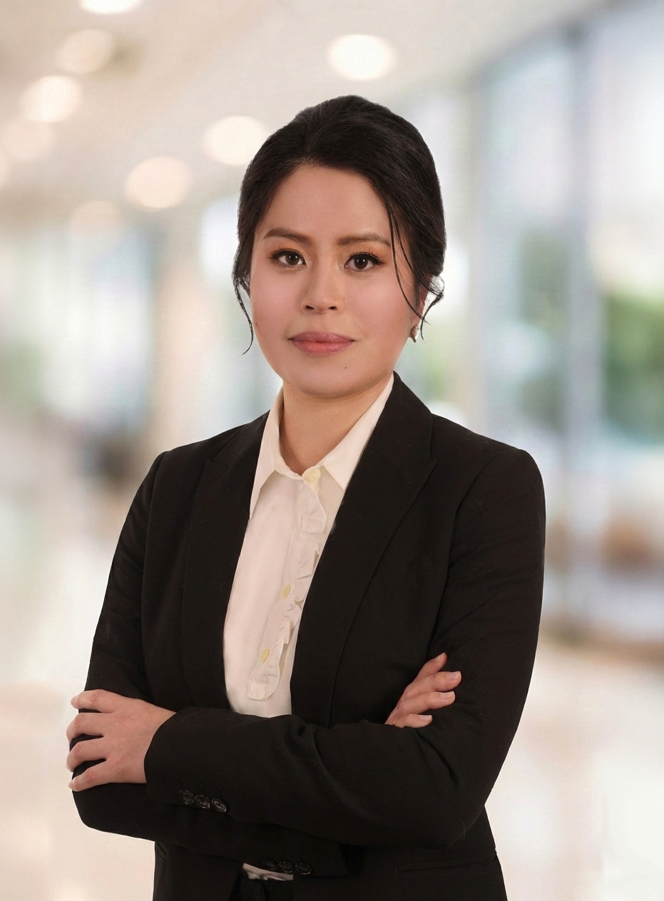 Professional headshot of Jessica Luong, employment lawyer, standing with arms crossed in a modern office setting