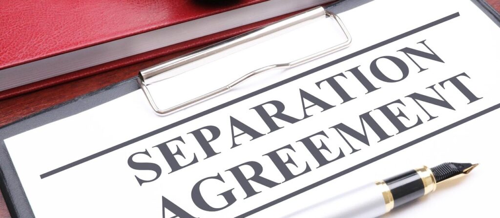 Document titled Separation Agreement on a clipboard with a fountain pen.